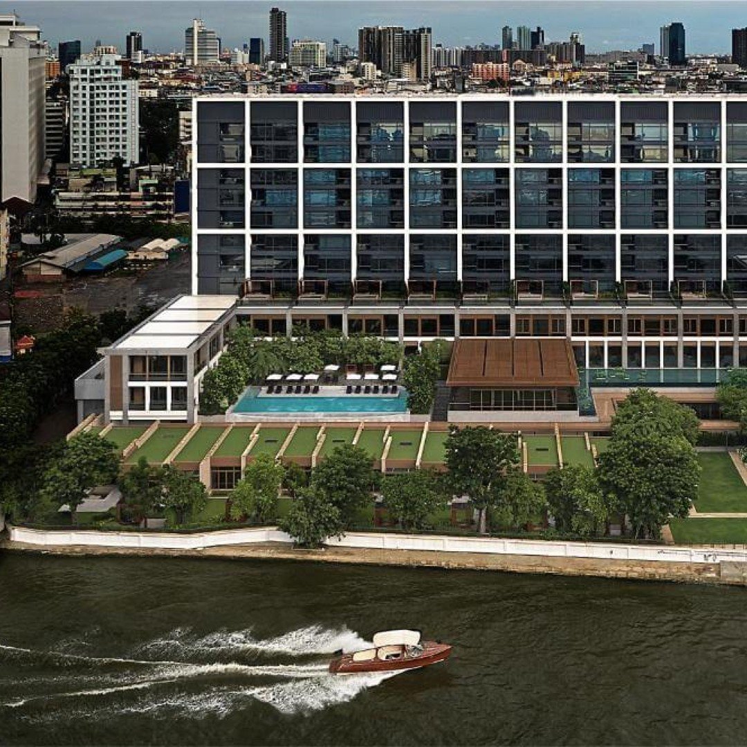 Capella Bangkok luxury riverside hotel exterior at dusk, Chao Phraya River