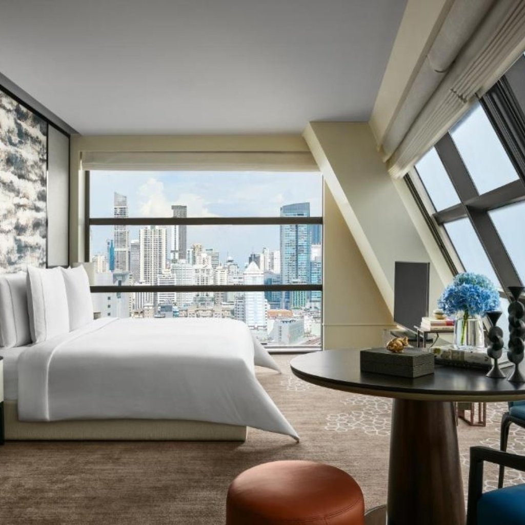 Rosewood Bangkok hotel interior bedroom featuring curated contemporary Thai art