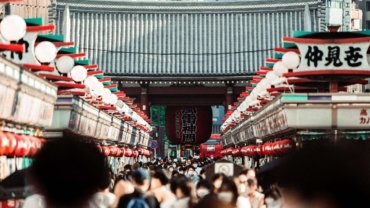 A bustling crowd in Nakamise Street, leading to Senso-ji Temple in Tokyo, Japan.
